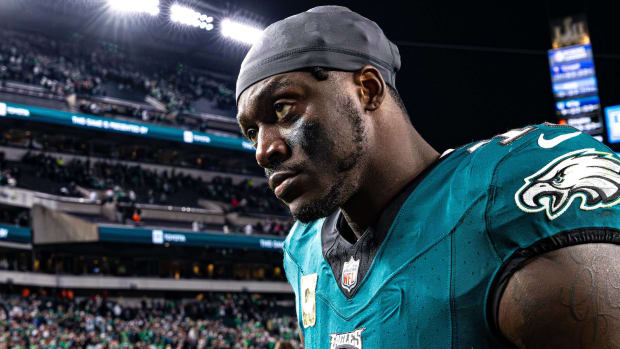 Philadelphia Eagles wide receiver A.J. Brown looks on without a helmet after a game.